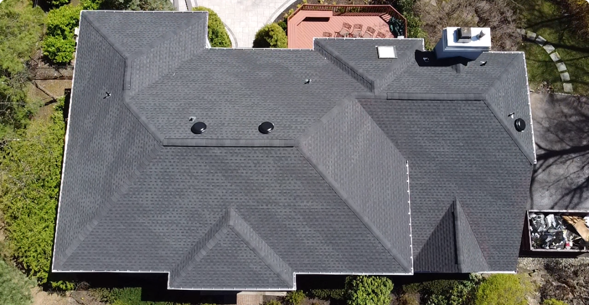 an aerial view of a house with a black roof.