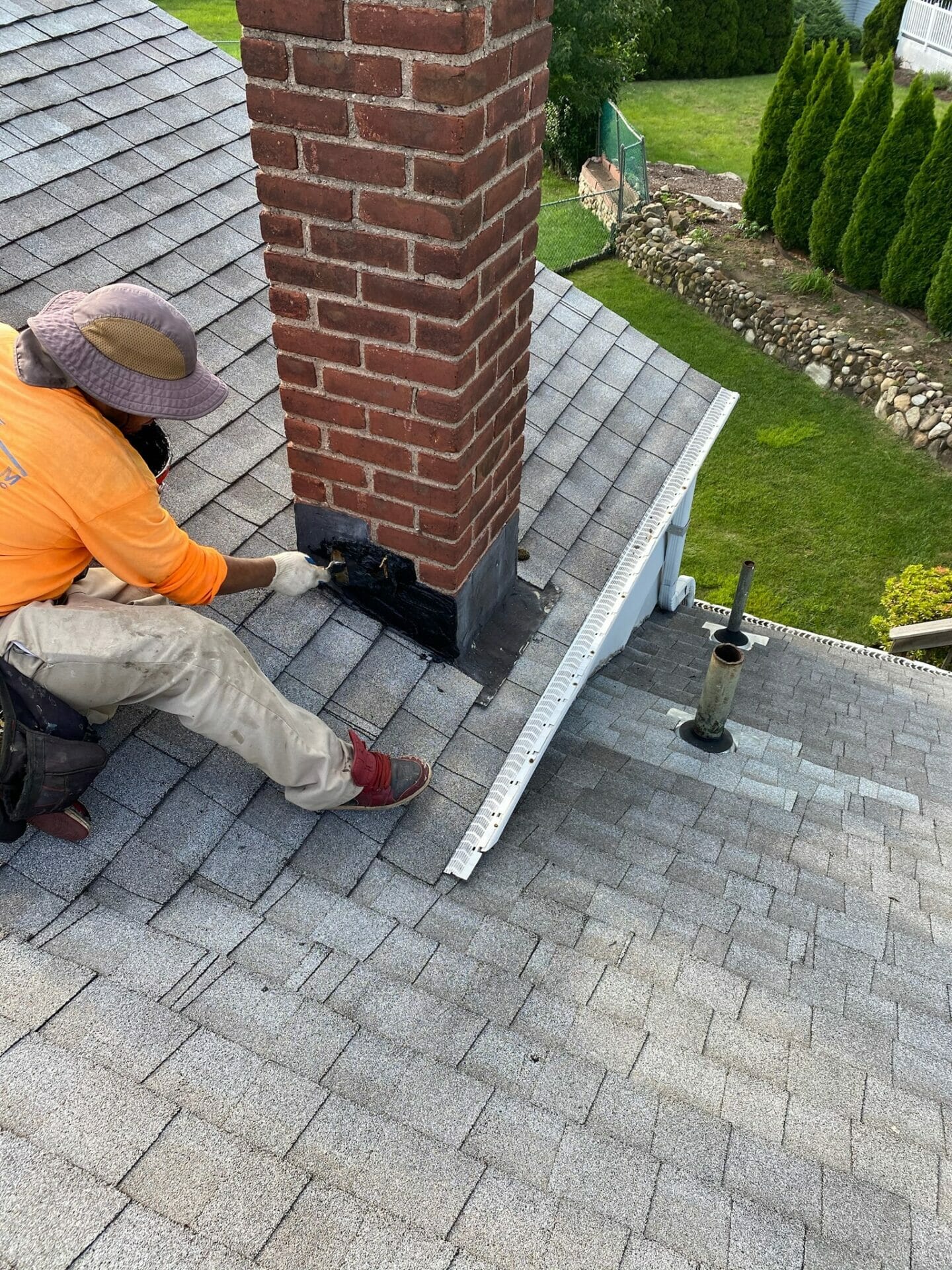 a man working on a chimney on a roof.
